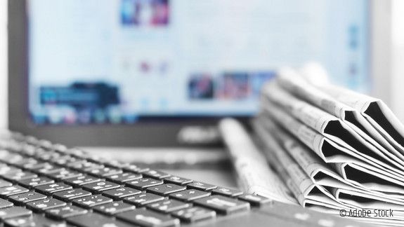 Newspapers and Laptop. Different Concepts for News - Network or