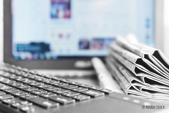 Newspapers and Laptop. Different Concepts for News - Network or